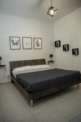 a large bed in a room with pictures on the wall at LION'S Room in Palermo