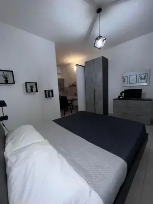 a bedroom with a large white bed in a room at LION'S Room in Palermo