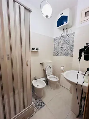 a bathroom with a toilet and a sink at LION'S Room in Palermo