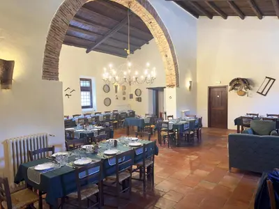 a dining room with tables and chairs and a chandelier at Le Case di Cardellino - AgriSpa in Sclafani