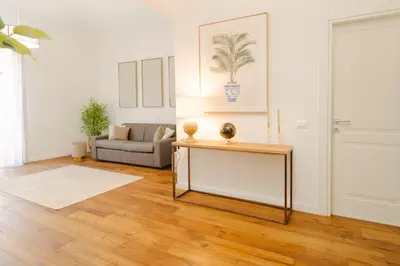 a living room with a table and a couch at La Duca Suites & Apartments in Palermo