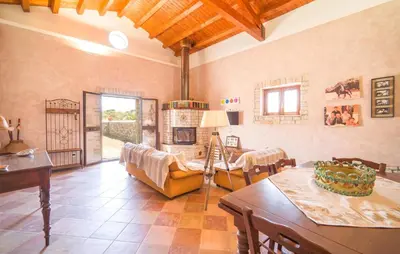 a living room with a table and a fireplace at Awesome Home In Palazzo Adriano in Palazzo Adriano