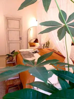 a bedroom with a bed with a mirror and a plant at Dream Penthouse over main Square in Palermo