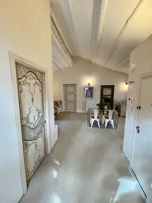 an empty hallway with a door with a painting on the wall at Dream Penthouse over main Square in Palermo