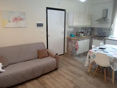 a living room with a couch and a table at Virginia Holiday Home in Mondello