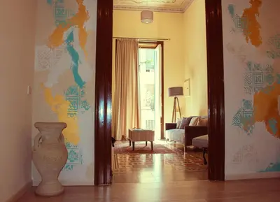a living room with a vase on the wall at Mizzica Rooms in Palermo