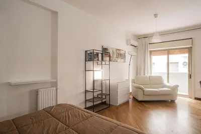 a living room with a couch and a chair at New Stabile APT Balcony central apartment in Palermo