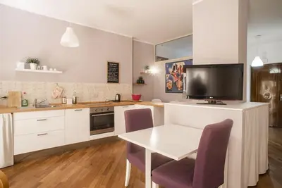 a kitchen with a table and a tv on a counter at New Stabile APT Balcony central apartment in Palermo