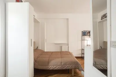 a bedroom with a bed in a white room at New Stabile APT Balcony central apartment in Palermo