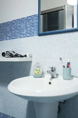 a bathroom with a white sink and a mirror at New Stabile APT Balcony central apartment in Palermo