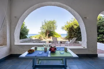 a table with a bowl of fruit on a patio at Casa Eugenia in Santa Flavia