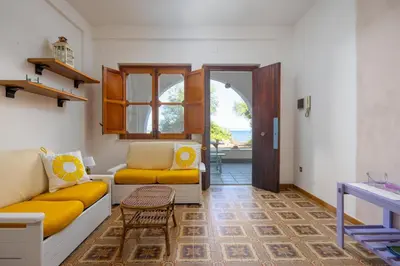 a living room with a couch and a table at Casa Eugenia in Santa Flavia