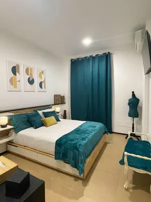 a bedroom with a bed and a blue curtain at La casa di Alice in Palermo