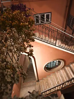 a hallway of a building with a staircase and a window at NBHouse in Palermo