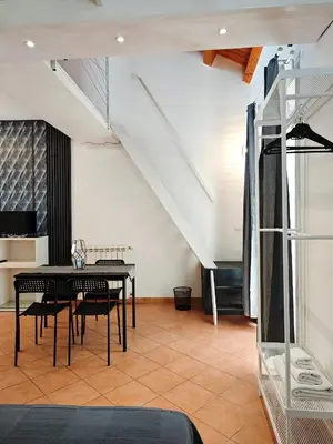 a dining room with a black table and chairs at NBHouse in Palermo