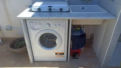 a washing machine under a counter in a kitchen at Il Fico d'India in San Vito lo Capo