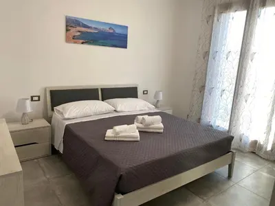 a bedroom with a bed with two towels on it at San Vito Holiday Home in San Vito lo Capo