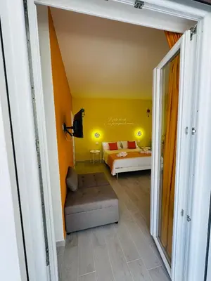 a living room with a couch and a bed at Sirio rooms and apartments in Carini