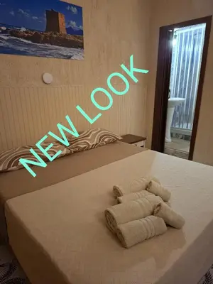 a bed with a sign that says new arousal at LA TERRAZZA SUL MARE camera vicino aereoporto&mare SICILIAN VINTAGE STYLE SEASIDE ROOM in Cinisi