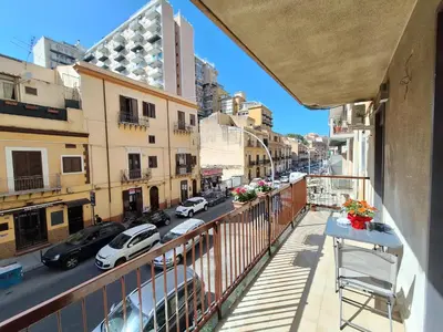 an apartment balcony with a view of a street at Casa cannella in Palermo