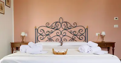 a bed with two towels and a basket on it at Villa Rubino, Addaura - Mondello in Palermo