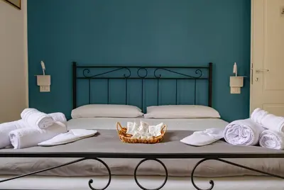 a bed with towels and a basket of towels at Villa Rubino, Addaura - Mondello in Palermo