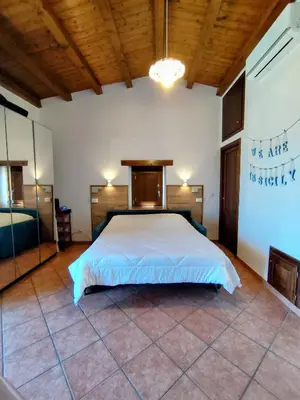 a bedroom with a large bed in a room at Open Space Marianna - Sea View in Trabia