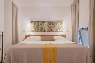 a bedroom with a bed with a yellow and white blanket at Resuttano Loft in Palermo