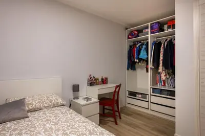 a bedroom with a bed and a desk with a chair at Villareale Flat - Palermo City Center Free Parking in Palermo