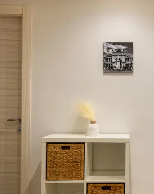 a white shelf with a basket on top of it at Villareale Flat - Palermo City Center Free Parking in Palermo