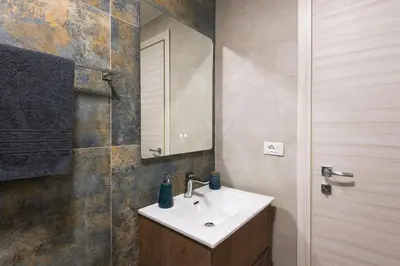 a bathroom with a sink and a mirror at Villareale Flat - Palermo City Center Free Parking in Palermo