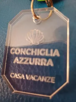 a key chain with a sign that readscongratulations argentinaazaazaaza at Conchiglia azzurra in Trappeto