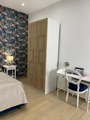 a bedroom with a desk and a bed and a table at Baglio porta d Ossuna in Palermo
