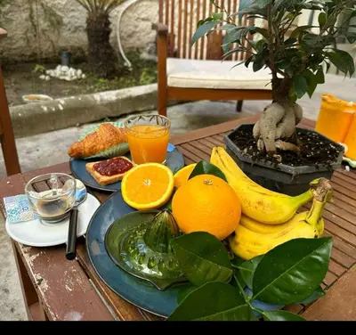 a plate of fruit sitting on a wooden table at Baglio porta d Ossuna in Palermo