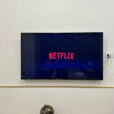 a television on a wall with the words netflix at Baglio porta d Ossuna in Palermo