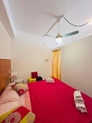 a bedroom with a large bed with a red blanket at Balestrate Mare Centro Wi-Fi Self Check-in Aria Condizionata in Balestrate