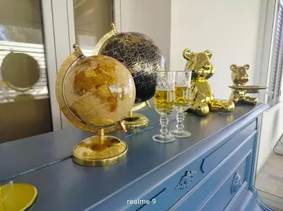 a blue dresser with a globe and glasses on it at Parco della Vittoria in Terrasini