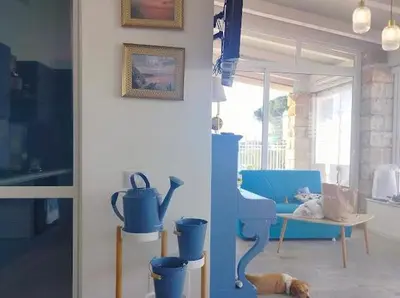 a table with blue glass vases and a cake on it at Parco della Vittoria in Terrasini