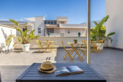 a bedroom with a bed and a desk in it at Casa Azzurra Rooms e apartment in Terrasini