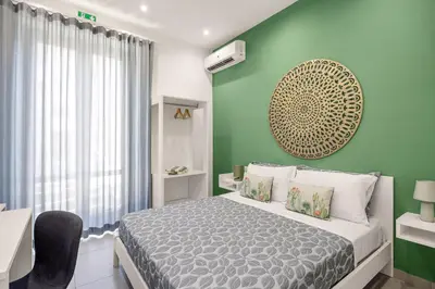 a white dining room with a white table with chairs at Casa Azzurra Rooms e apartment in Terrasini