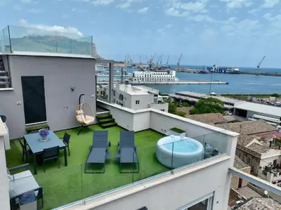 a balcony with a hot tub and a table and chairs at Marina Rooftop Exclusive View in Palermo