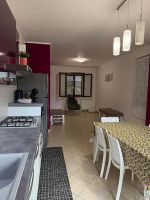 a kitchen and dining room with a table and chairs at Fun House in Trabia