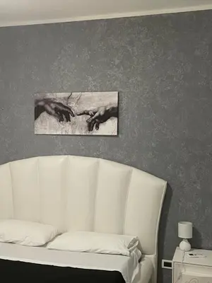 a white couch in a room with a picture on the wall at Fun House in Trabia