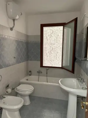 a bathroom with a tub and a toilet and a sink at Fun House in Trabia