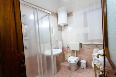 a bathroom with a toilet and a sink and a shower at Pegaso 15 Home in Palermo