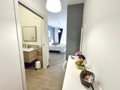 a bathroom with a sink and a vanity with a mirror at Domus Livi in Cinisi