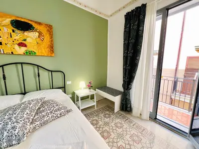 a bedroom with a bed and a large window at Domus Livi in Cinisi