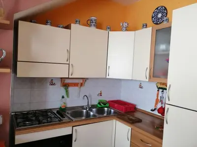 a kitchen with white cabinets and a sink at Casa Cinque Torri in San Vito lo Capo