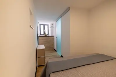 a bedroom with a bed and a staircase in the background at aprimaManu apartment in Monreale