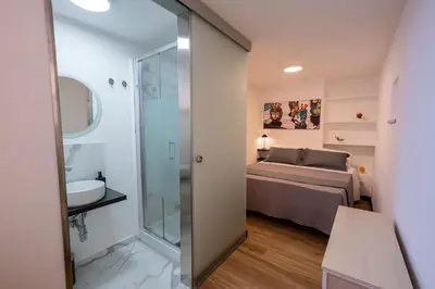 a bathroom with a shower and a bed in a room at aprimaManu apartment in Monreale